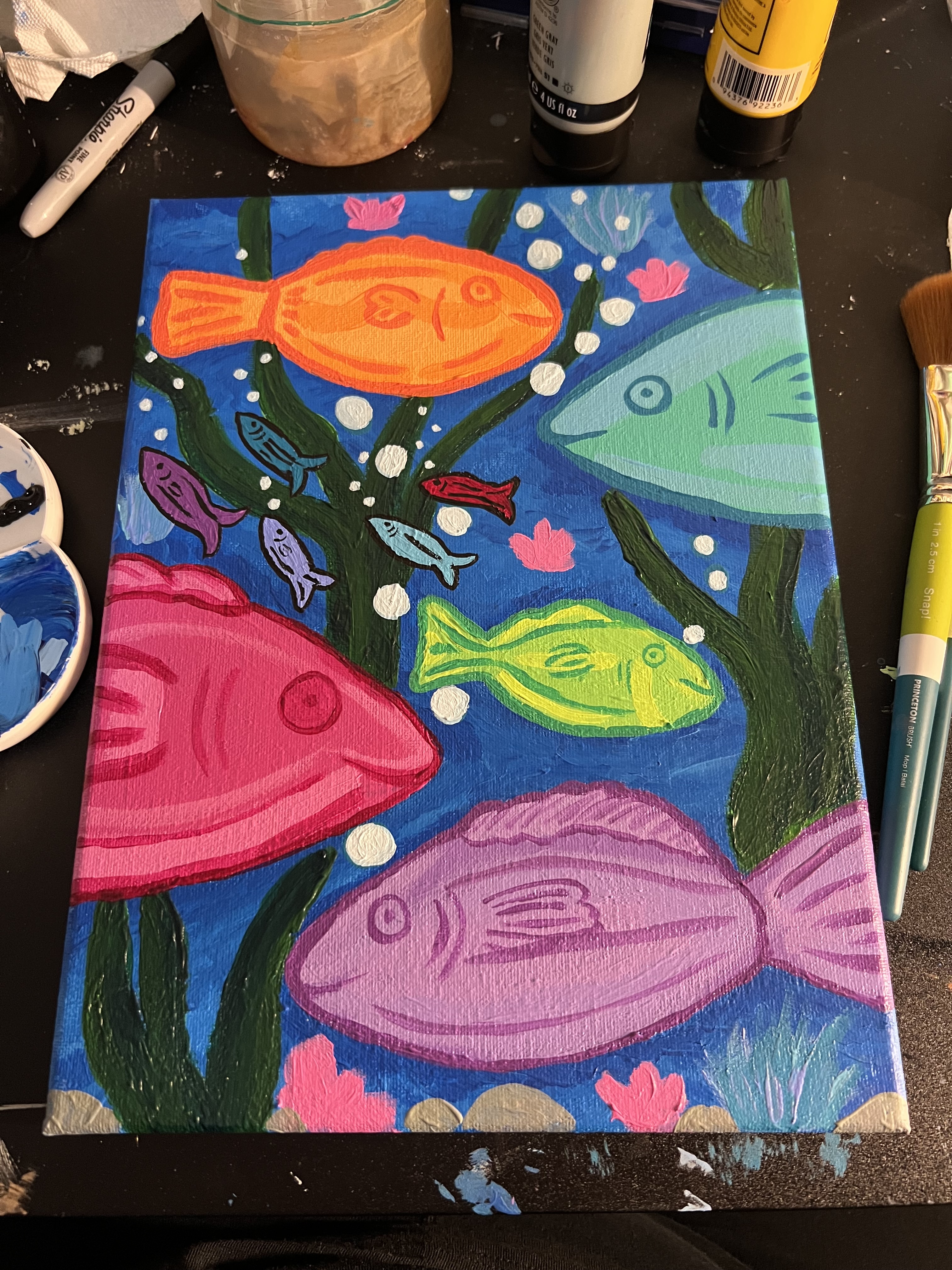 colourful painting of different sizes of fish swimming through kelp. 