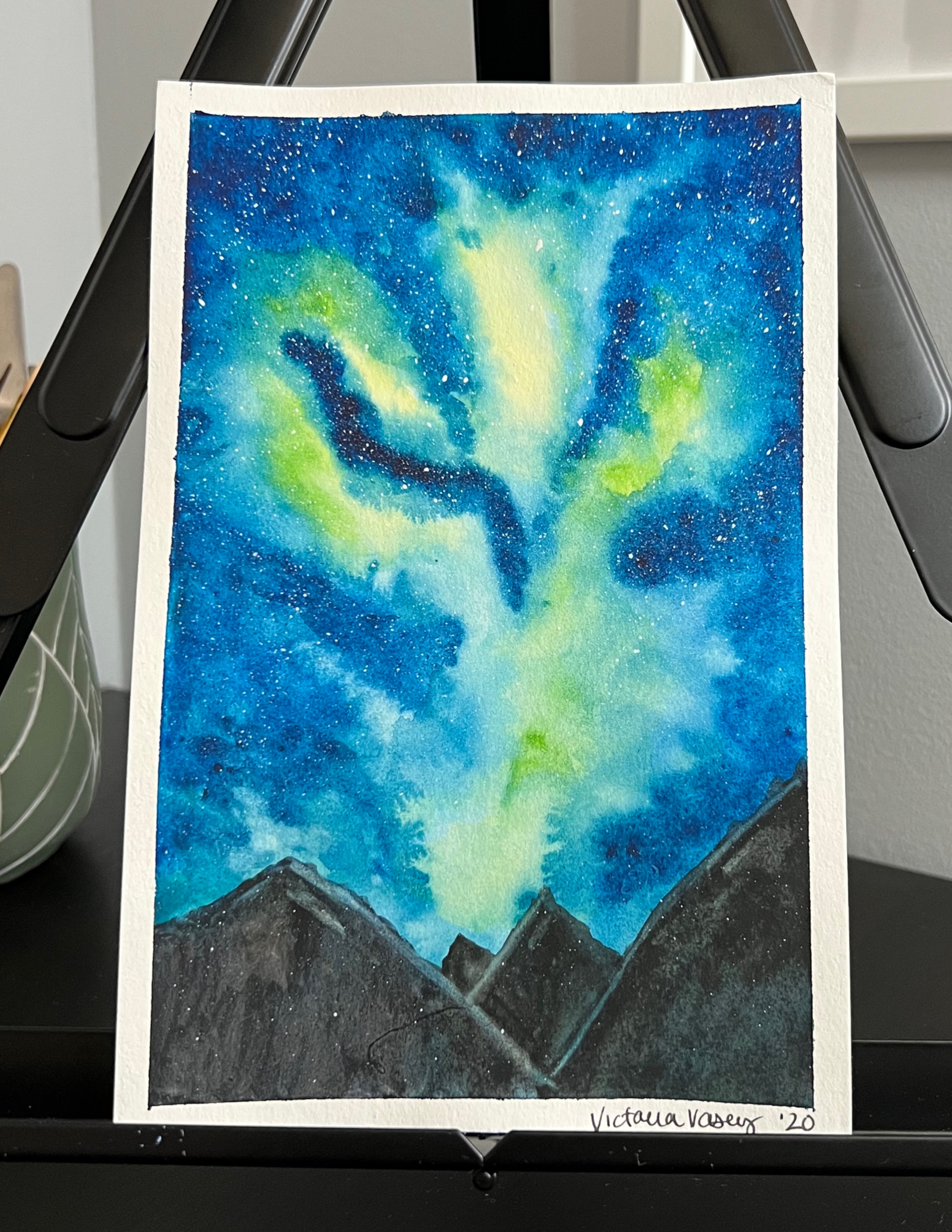 watercolour painting of a mountain range with the northern lights in the sky 