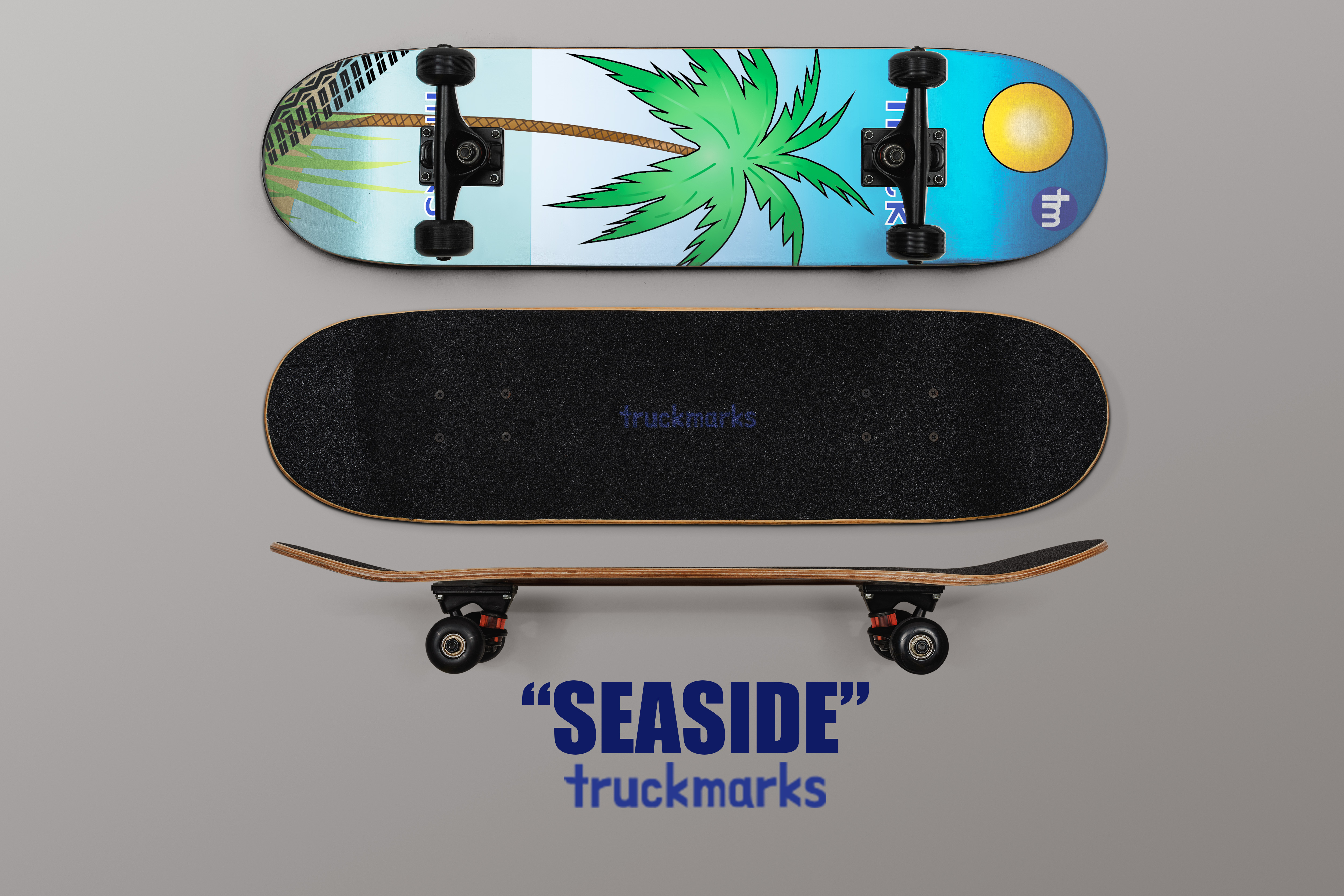 Skateboard mockup with a tropical beach illustration including a palm tree, sun, and ocean tones, displayed from top, grip, and side views with trucks and wheels, labeled “Seaside” by Truckmarks.
